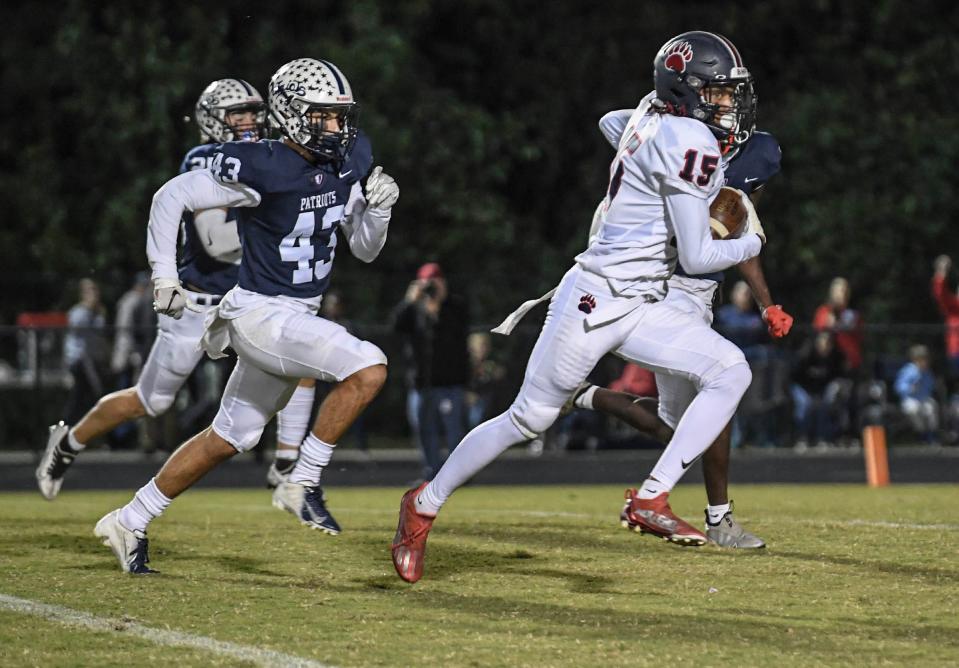 Belton Honea Path senior Nevada Billups (15) runs by Powdersville senior Jack Quarles(43) for a touchdown during the fourth quarter at Powdersville High in Greenville, S.C. Thursday, September 29, 2022.