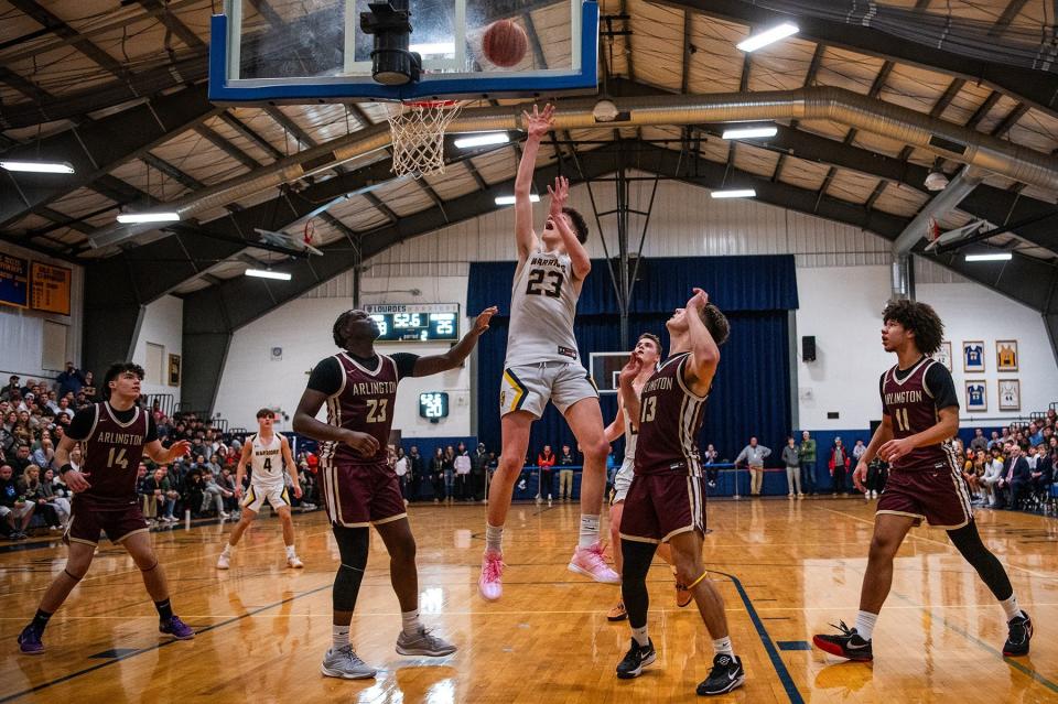 Lourdes' Zach Hart goes for a layup against Arlington during the Duane Davis Memorial Tournament final on Dec. 29, 2023.