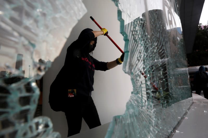 An anti-government protester cleans up after protests at the Polytechnic University in Hong Kong