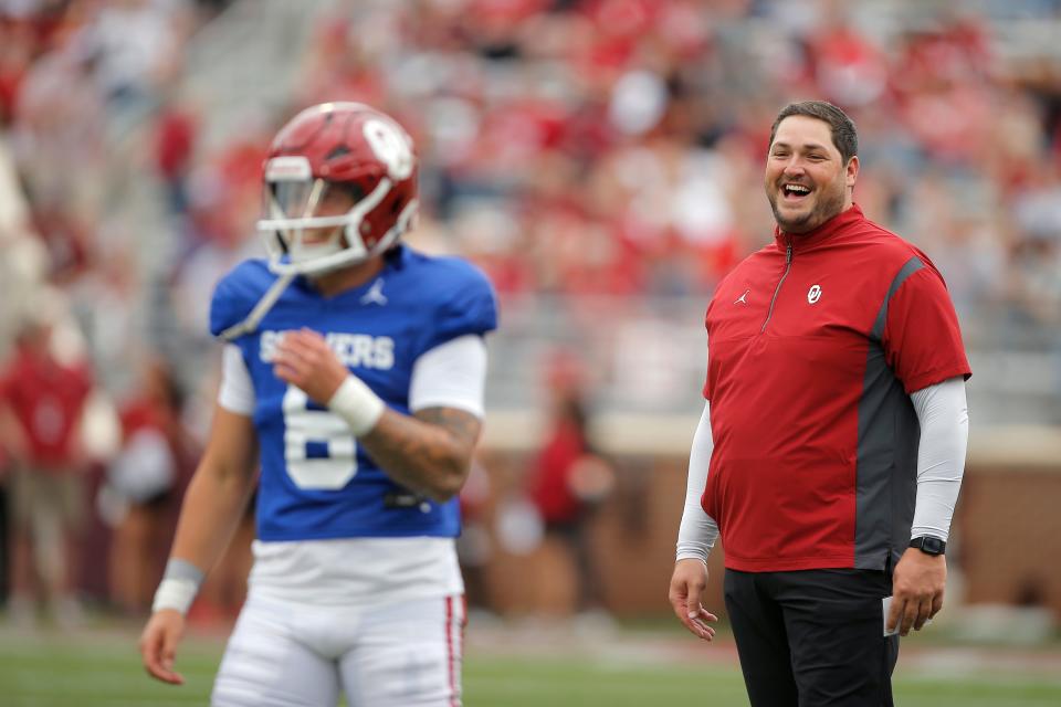 Offensive coordinator Jeff Lebby laughs behind Dillon Gabriel (8) warms up before the University of Oklahoma's annual spring football game at Gaylord Family-Oklahoma Memorial Stadium in Norman, Okla., Saturday, April 23, 2022. 