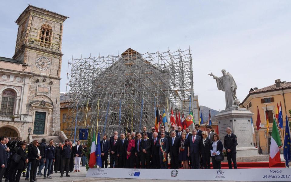 MEPs visited the historic centre of Norcia last week, posing for a photograph in front of the damaged facade of the Basilica of St Benedict. - Credit: EPA