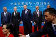 A security agent reacts as a woman tries to have a pictures taken in front of Turkey's President Tayyip Erdogan (C) and his delegation after the closing of G20 Summit in Hangzhou, Zhejiang Province, China, September 5, 2016. REUTERS/Damir Sagolj