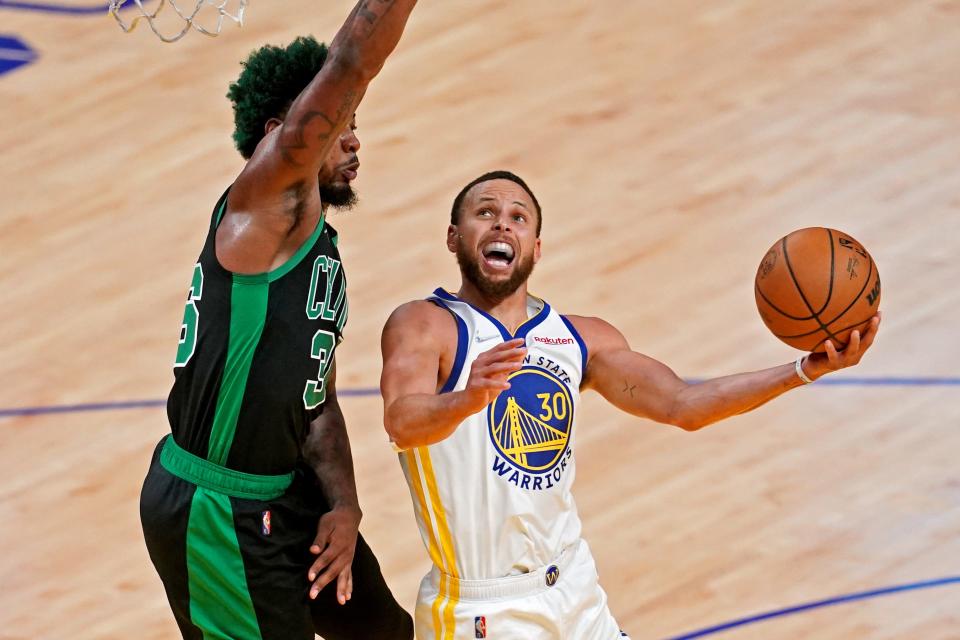 Golden State Warriors guard Stephen Curry (30) shoots the ball against Boston Celtics guard Marcus Smart (36) in game five of the 2022 NBA Finals at Chase Center.