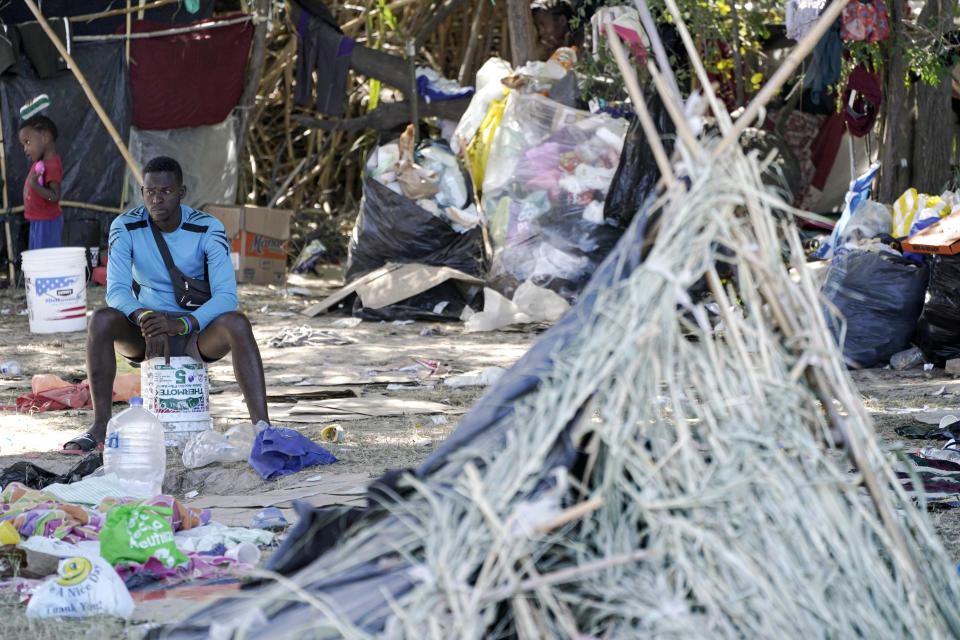 A migrant man is seen next to a hut in an encampment under the Del Rio International Bridge where migrants, many from Haiti, have been staying after crossing the Rio Grande, Thursday, Sept. 23, 2021, in Del Rio, Texas. (AP Photo/Julio Cortez)