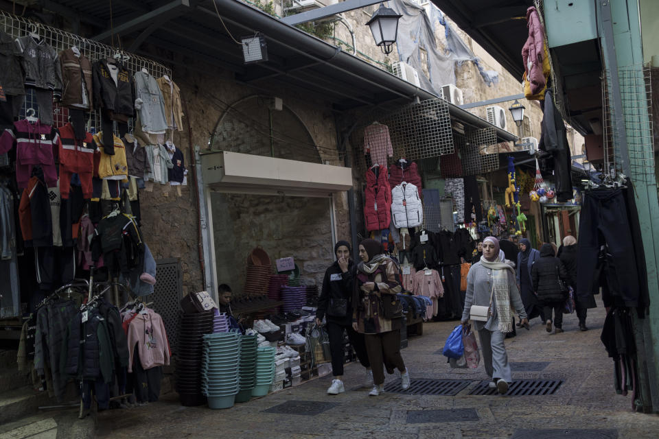 File - Muslim women walk through a market, ahead of the holy Islamic month of Ramadan, in the Old City of Jerusalem, Thursday, March 7, 2024. Restrictions put in place amid the Israel-Hamas war have left many Palestinians concerned they might not be able to pray at Al-Aqsa Mosque compound, which is revered by Muslims. (AP Photo/Leo Correa, File)