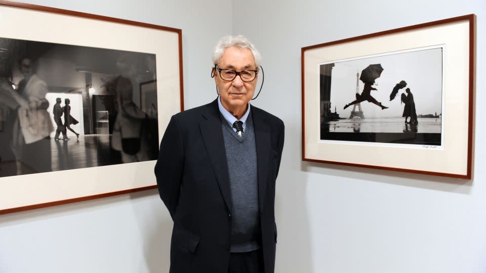 Erwitt poses with two framed examples of his work at the 2010 retrospective "Elliot Erwitt : Personal Best," presented at La Maison Europeenne de la Photographie (MEP) in Paris. - Miguel Medina/AFP/Getty Images