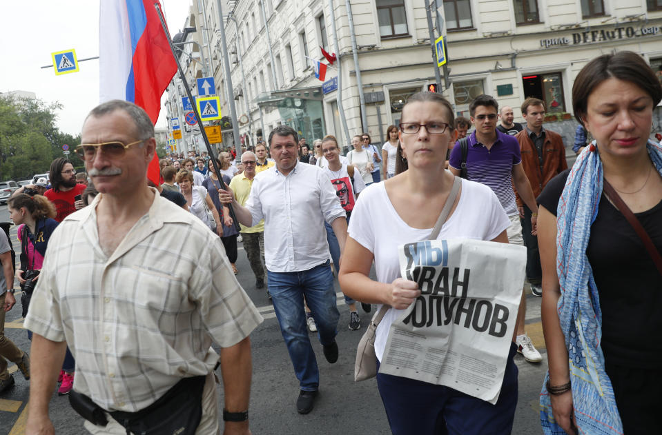 Supporters of Russian investigative journalist Ivan Golunov and other protesters gather to attend a march in Moscow, Russia, Wednesday, June 12, 2019. (AP Photo/Pavel Golovkin)