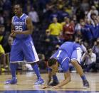 Kentucky's James Young (1) and Dominique Hawkins (25) react during the second half of an NCAA Midwest Regional final college basketball tournament game against Michigan Sunday, March 30, 2014, in Indianapolis. (AP Photo/David J. Phillip)