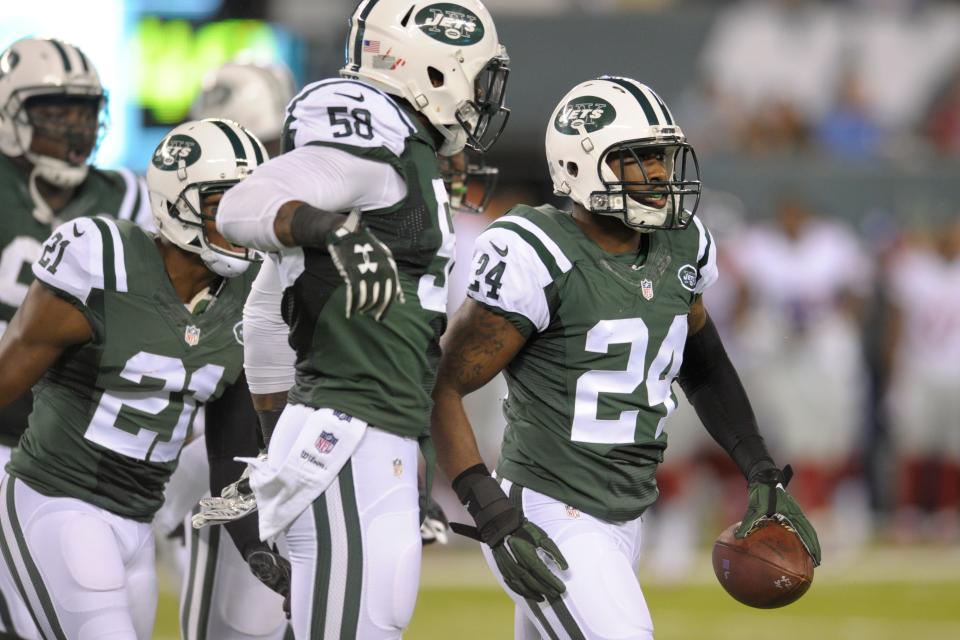 New York Jets cornerback Darrelle Revis (24) celebrates with teammates after intercepting a pass during the first half of an NFL preseason football game against the New York Giants Saturday, Aug. 27, 2016, in East Rutherford, N.J.  (AP Photo/Bill Kostroun)