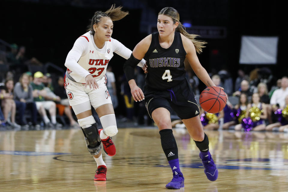 Washington's Amber Melgoza (4) drives around Utah's Daneesha Provo (23) during the first half of an NCAA college basketball game in the first round of the Pac-12 women's tournament Thursday, March 5, 2020, in Las Vegas. (AP Photo/John Locher)