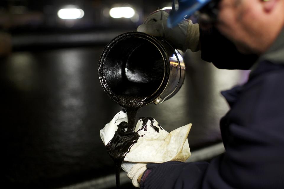 An oil sands worker checks the oil during the first step of separation at the Suncor processing plant at their tar sands operations near Fort McMurray, Alberta, September 17, 2014. In 1967 Suncor helped pioneer the commercial development of Canada's oil sands, one of the largest petroleum resource basins in the world. Picture taken September 17, 2014. REUTERS/Todd Korol (CANADA - Tags: ENERGY ENVIRONMENT)