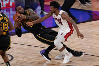 Los Angeles Lakers forward LeBron James pulls rebound away from Miami Heat forward Jimmy Butler during the second half in Game 5 of basketball's NBA Finals Friday, Oct. 9, 2020, in Lake Buena Vista, Fla. (AP Photo/Mark J. Terrill)