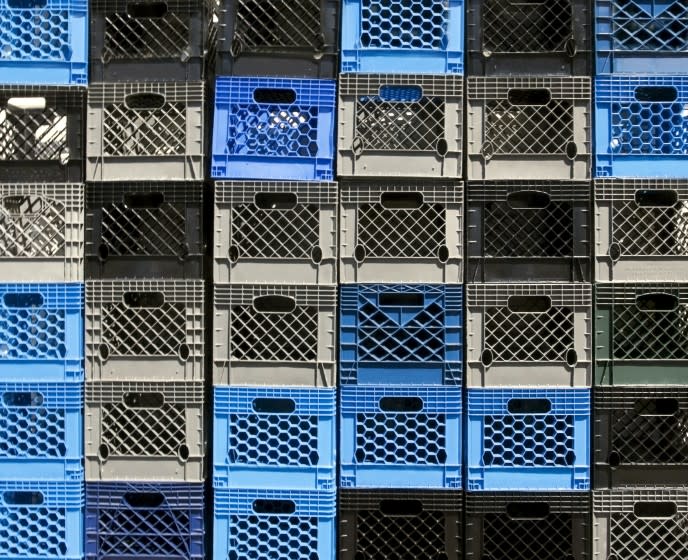 A wall of empty, multi-colored milk crates Horizontal.-For more jars, boxes, containers, bottles, and bags click here. JARS, BOXES, CONTAINERS, BOTTLES, and BAGS