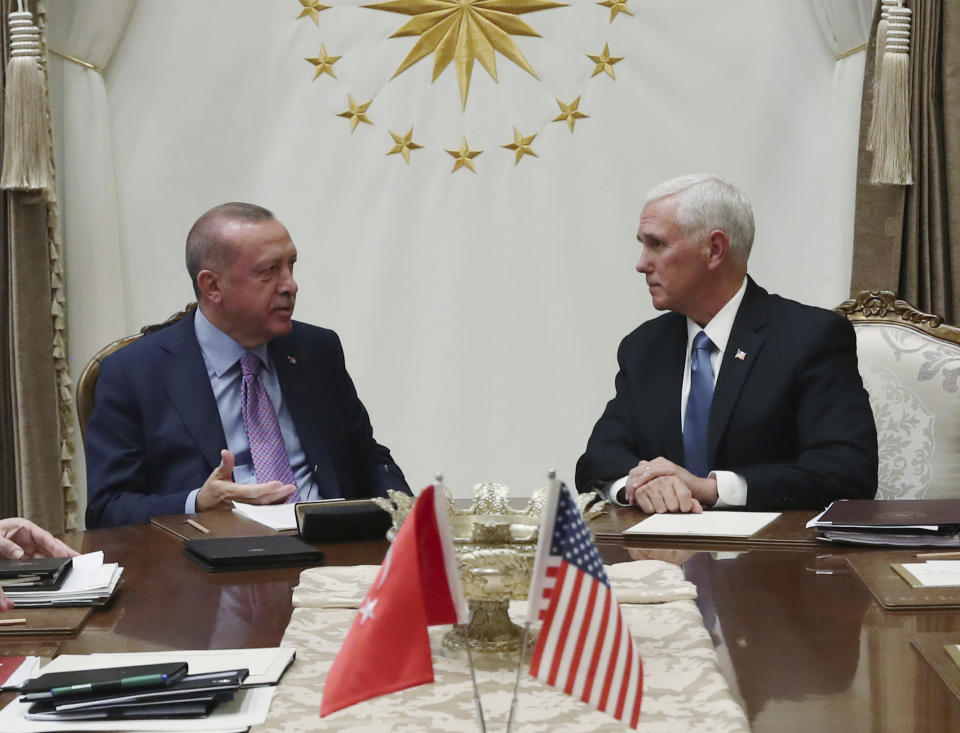 Turkey's President Recep Tayyip Erdogan, left, talks with U.S Vice President Mike Pence, during their meeting at the Presidential Palace in Ankara, Turkey, Thursday, Oct. 17, 2019. A high level U.S. delegation arrived in Turkey on Thursday for talks on a cease-fire in Syria. (Presidential Press Service via AP, Pool)