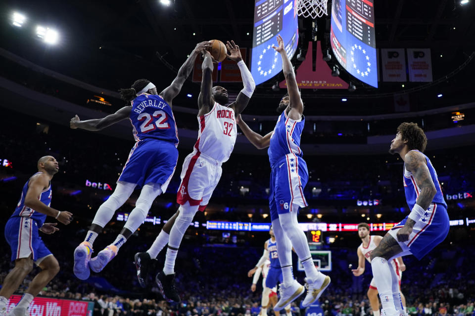 Houston Rockets' Jeff Green (32) goes up for a shot against Philadelphia 76ers' Joel Embiid (21) and Patrick Beverley (22) during the first half of an NBA basketball game, Monday, Jan. 15, 2024, in Philadelphia. (AP Photo/Matt Slocum)