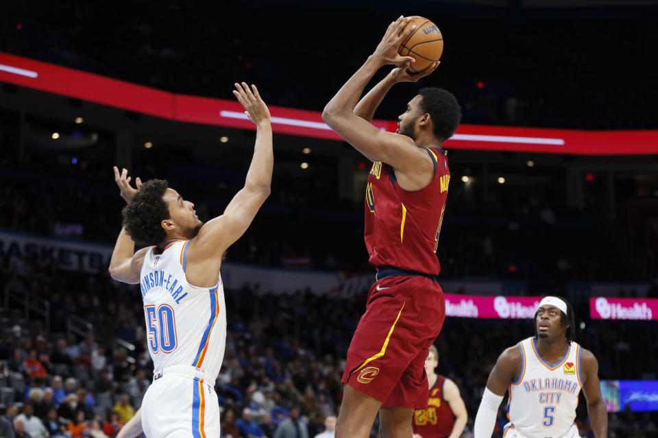 Cleveland Cavaliers forward Evan Mobley, front right, shoots over Oklahoma City Thunder forward Jeremiah Robinson-Earl (50) in the first half of an NBA basketball game Saturday, Jan. 15, 2022, in Oklahoma City. (AP Photo/Nate Billings)
