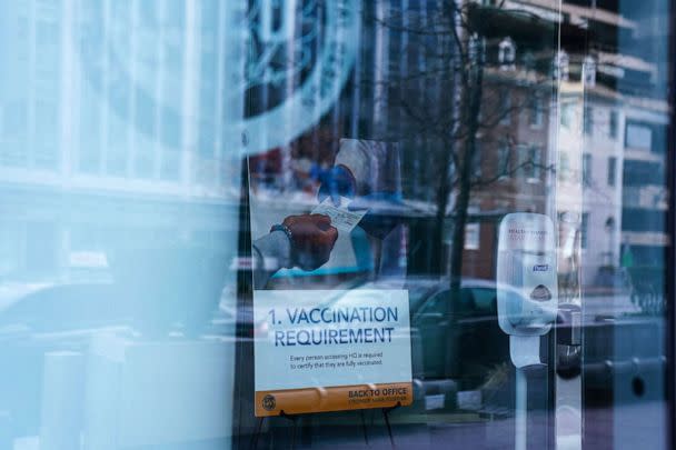 PHOTO: In this Jan. 31, 2022, file photo, a sign requiring proof of a COVID-19 vaccination is displayed inside of an office building in Washington, D.C. (Sarah Silbiger/Reuters, FILE)