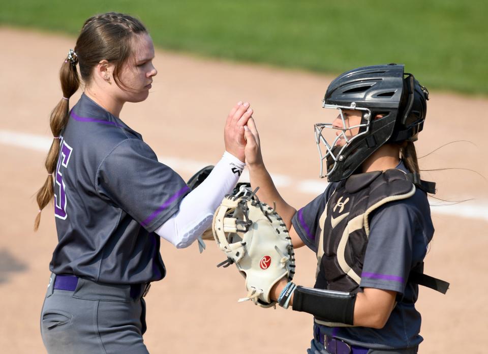 Jackson pitcher Julia Gossett and catcher Morgan Christopher finish the second inning against Hoover in the Division I district final in Massillon, Wednesday, May 17, 2023.