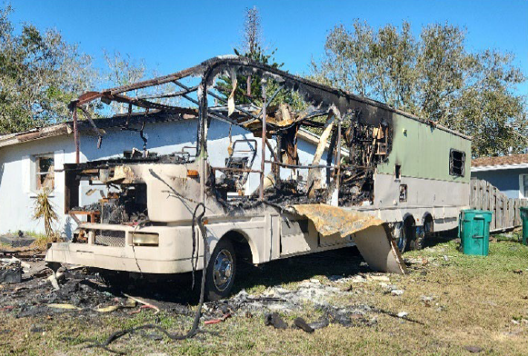 This Feb. 14 photo shows the recreational vehicle that caught fire at 4445 Sherwood Blvd. The charred RV remains alongside the home — and a Melbourne City Council member said the occupants have been chopping off pieces of metal and selling them.
