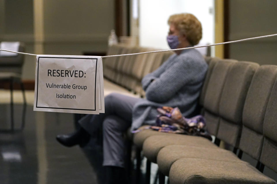 An older Highland Colony Baptist Church member sits in the reserved section for vulnerable adults in the Worship Center in Ridgeland, Miss., Nov. 29, 2020. The church practices covid protocols by allowing families to sit spaced out from others, separating older and more vulnerable members and providing sanitizer and masks at the entrance. (AP Photo/Rogelio V. Solis)