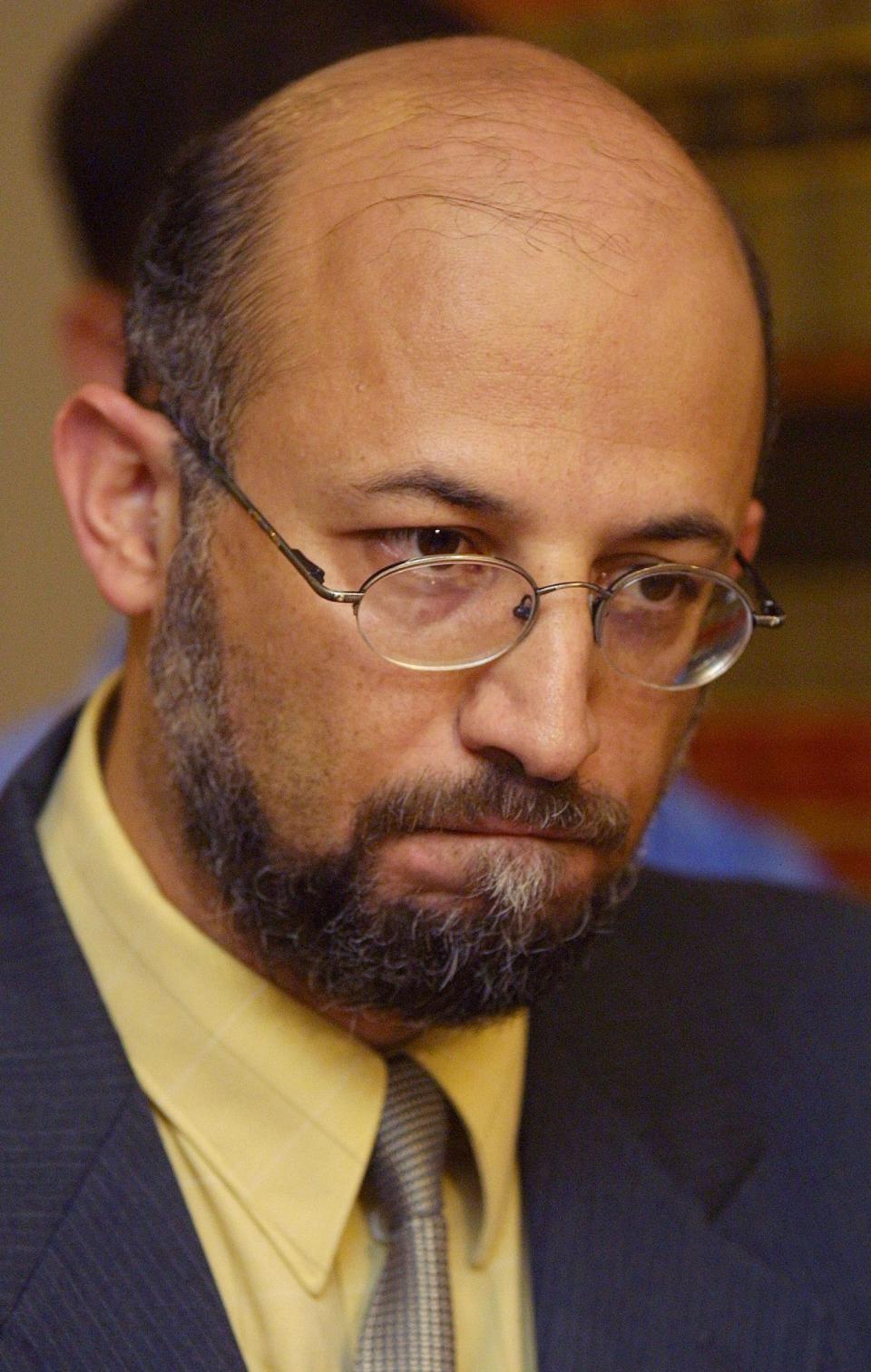 Professor Sami Al-Arian wearing a yellow shirt and dark jacket as he denies Ties To Terrorists at news conference in 2001