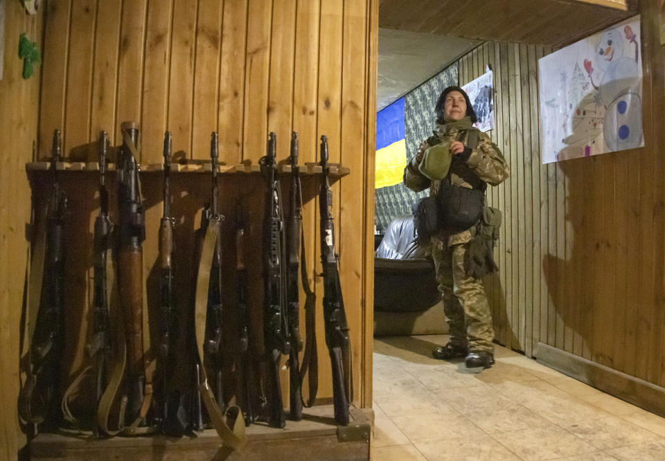 A Ukrainian female soldier takes a rest near a fighting position on the line of separation from pro-Russian rebels, Donetsk region, Ukraine, Thursday, Dec 30, 2021. Presidents Joe Biden and Vladimir Putin spoke by phone on Thursday about the Russian troop buildup near Ukraine. (AP Photo/Andriy Dubchak)