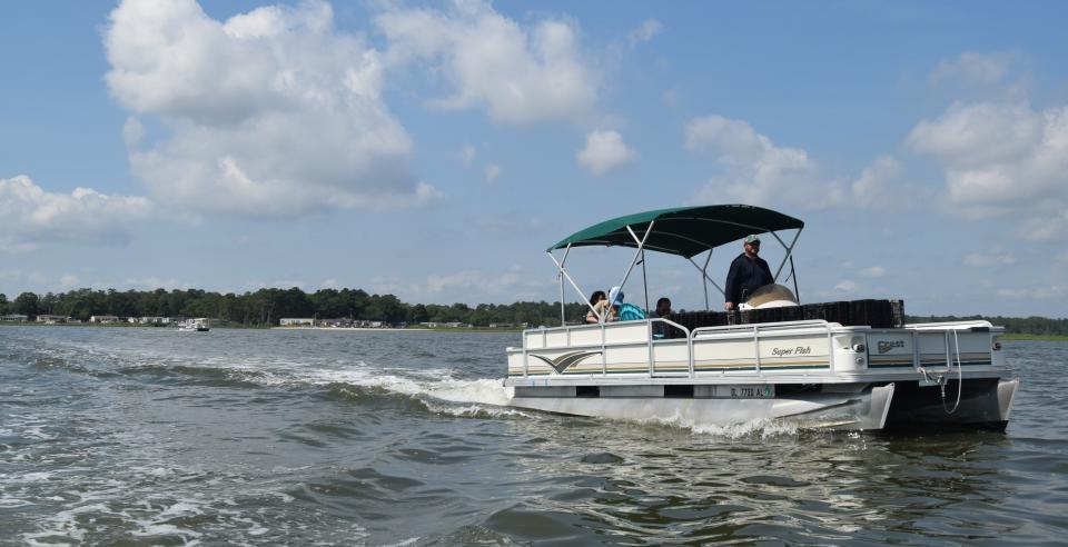 Waterman Chuck Gifford drives a boat out to an oyster farm on Rehoboth Bay in 2019.