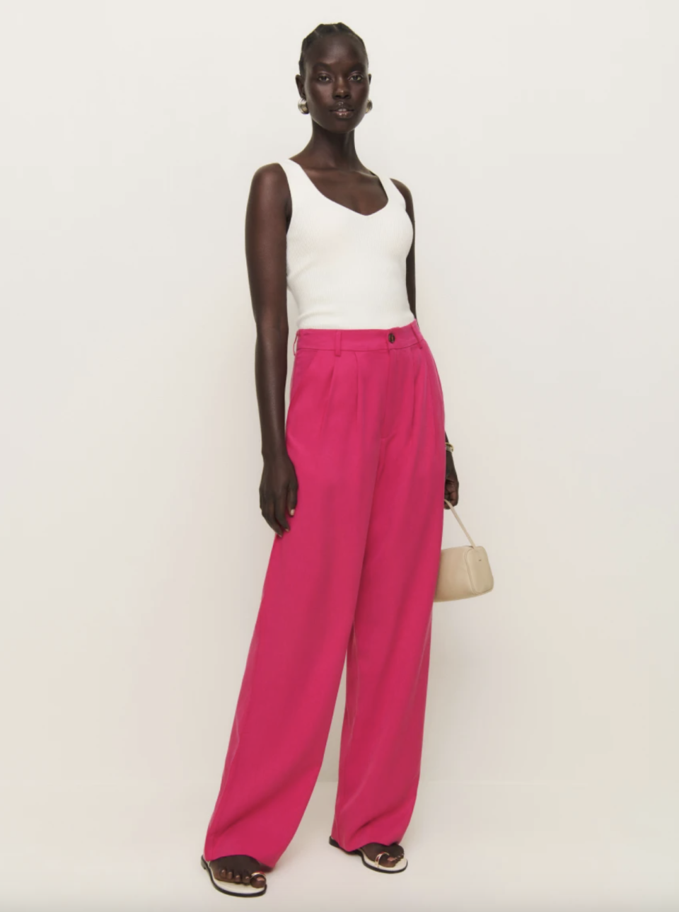 woman wearing white tank top and hot pink Mason Pant (Photo via Reformation).