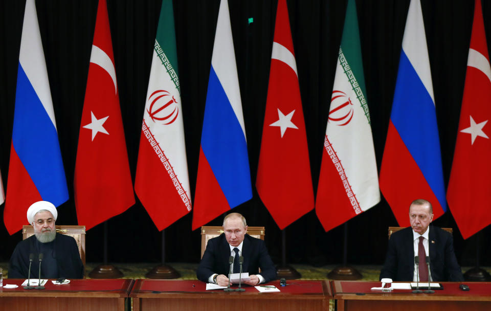 Russian President Vladimir Putin, center, Iranian President Hassan Rouhani, left, and Turkish President Recep Tayyip Erdogan, right attend a news conference after the talks in the Bocharov Ruchei residence in the Black Sea resort of Sochi, Russia, Thursday, Feb. 14, 2019. Putin hosted the leaders of Turkey and Iran for talks about a Syria peace settlement as expectations mount for an imminent and final defeat of the Islamic State group(Presidential Press Service via AP, Pool)