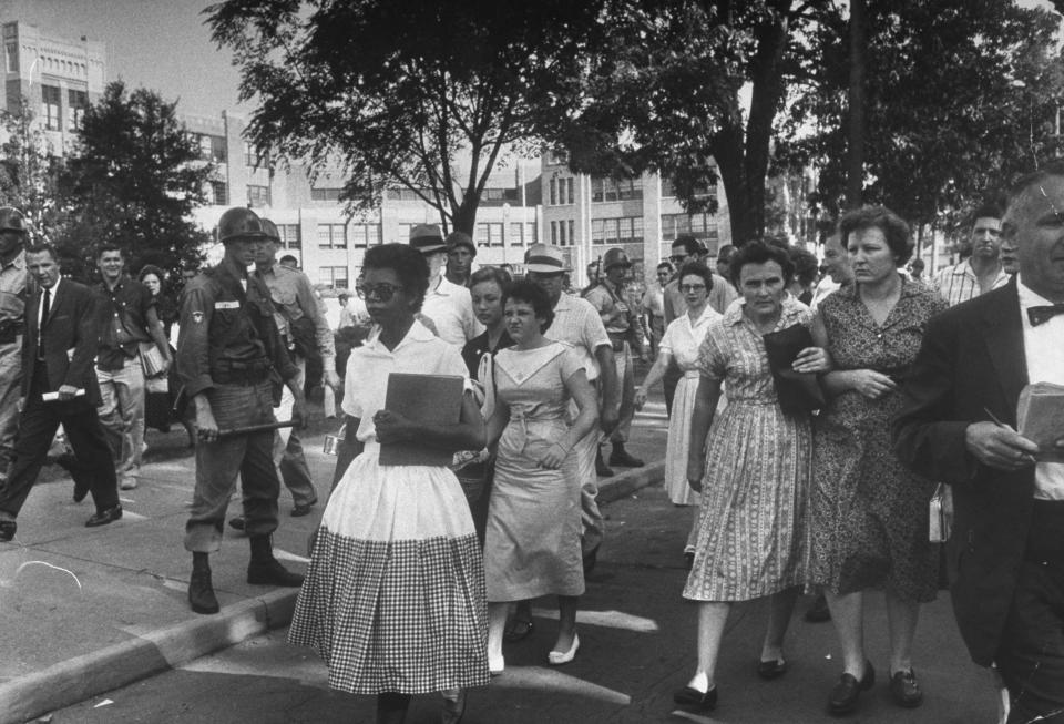 Teenager Elizabeth Eckford (L) w. snarling white parents following as she is turned away fr. entering Central High School by Arkansas National Guardsmen under orders fr. Gov. Orval Faubus.  