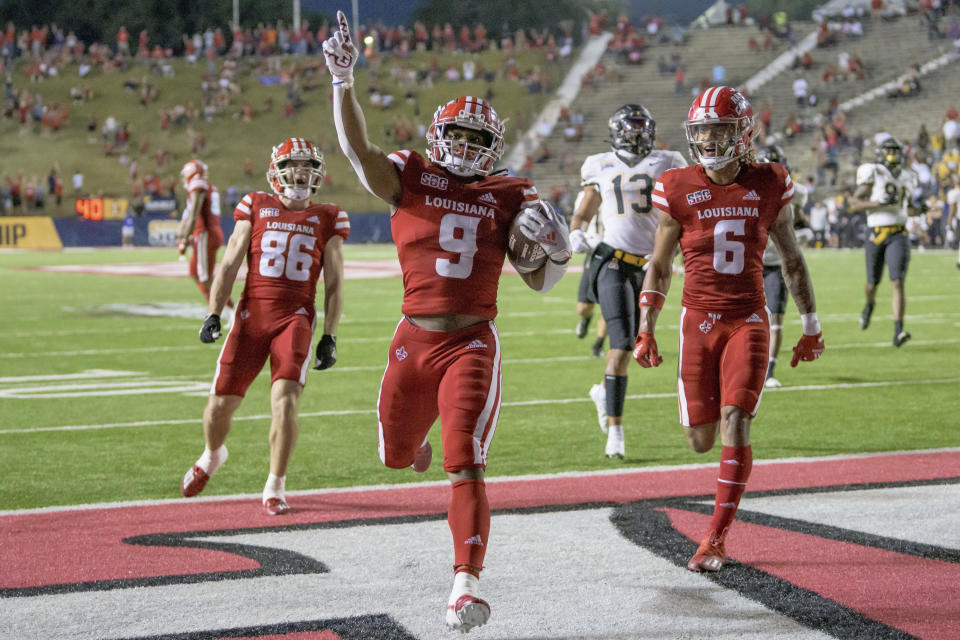 Louisiana-Lafayette running back Emani Bailey (9) celebrates a touchdown in the second half during the Sun Belt Conference championship NCAA college football game against Appalachian State in Lafayette, La., Saturday, Dec. 4, 2021. (AP Photo/Matthew Hinton)