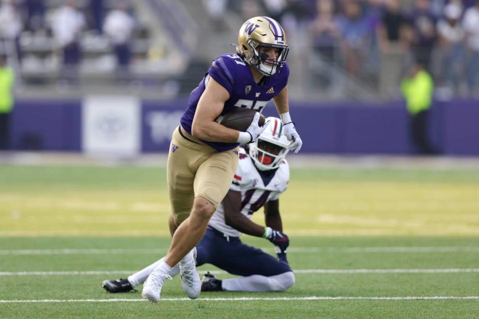 Washington tight end Jack Westover runs with the ball after breaking a tackle attempt by Arizona safety DJ Warnell Jr. on a pass run play during the second half of an NCAA football game, Saturday, Oct. 15, 2022, in Seattle. Washington won 49-39. (AP Photo/John Froschauer)