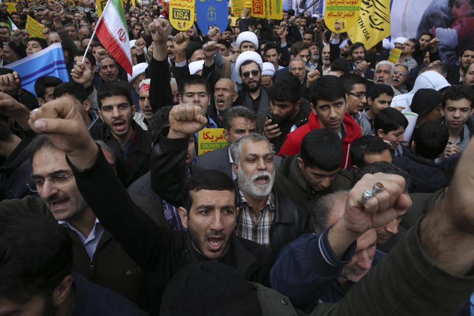 Demonstrators chant slogans during a rally in front of the former U.S. Embassy in Tehran, Iran, on Sunday, Nov. 4, 2018, marking the 39th anniversary of the seizure of the embassy by militant Iranian students. Thousands of Iranians rallied in Tehran on Sunday to mark the anniversary as Washington restored all sanctions lifted under the nuclear deal. (AP Photo/Vahid Salemi)