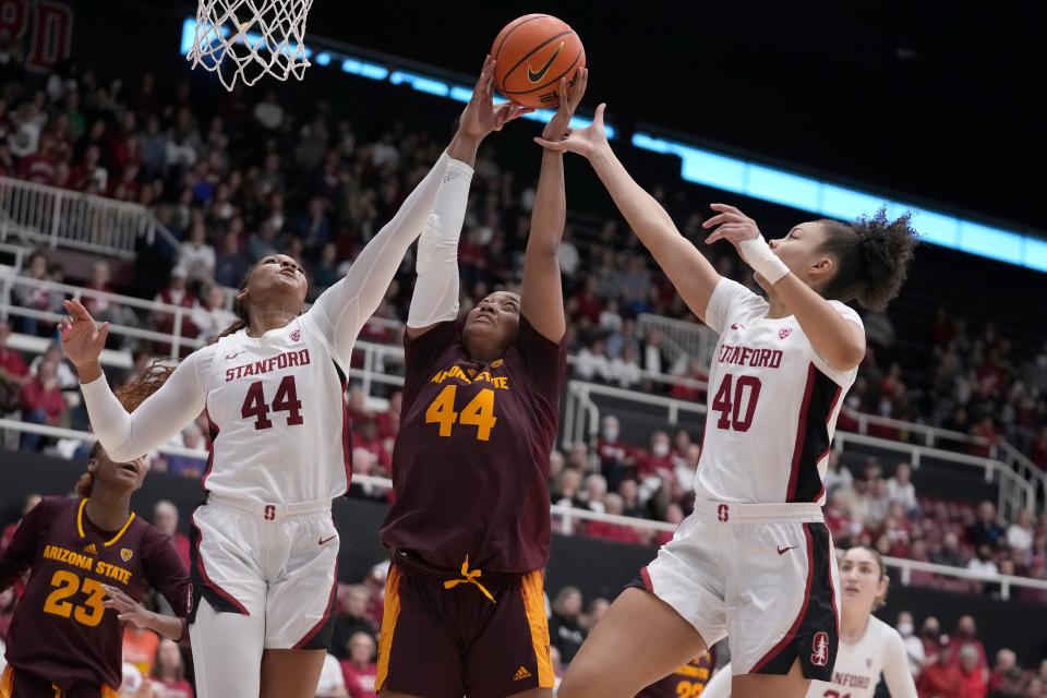 Arizona State guard Isadora Sousa, middle, grabs a rebound between Stanford forward Kiki Iriafen, left, and forward Courtney Ogden (40) during the first half of the game in Stanford, California, Sunday, Feb. 25, 2024.