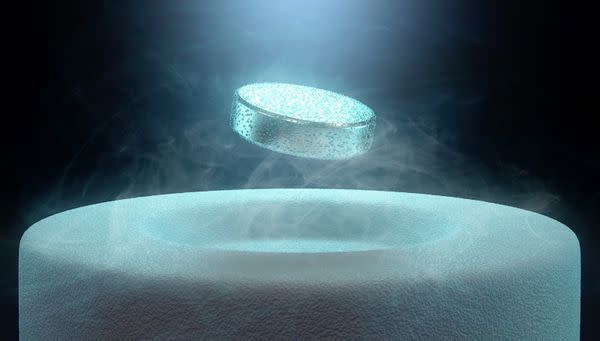  A blue metal cell-shaped object levitating above a surface. 