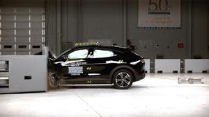 The all-electric 2021 Ford Mustang Mach-E in the IIHS 40-mph driver-side small overlap crash test. The Mach-E earns good ratings in six crashworthiness tests and qualifies for a TOP SAFETY PICK award when equipped with specific headlights.