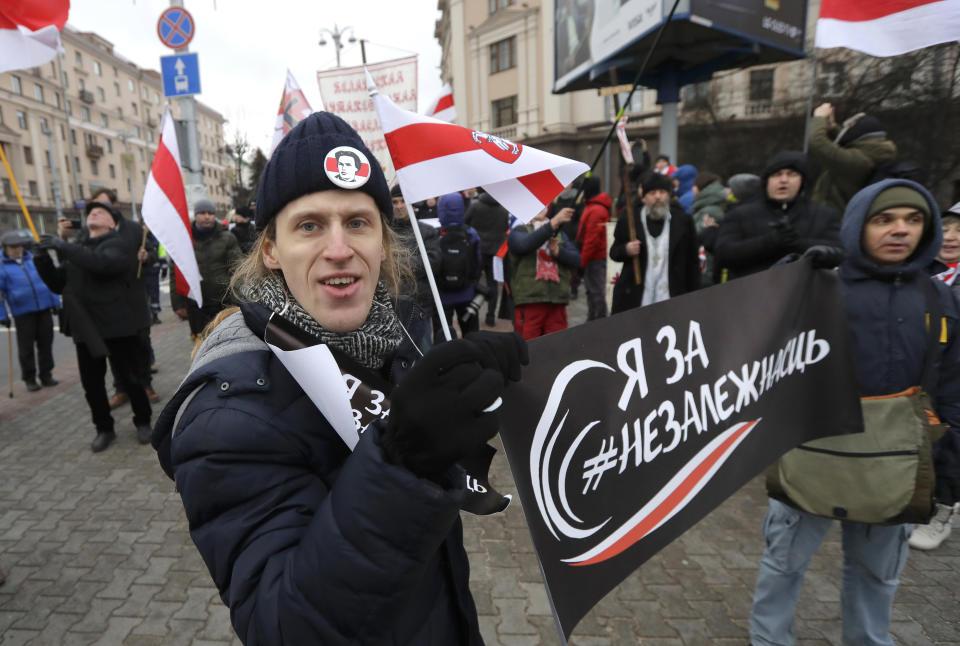 Protesters attend a procession in downtown Minsk, Belarus, Sunday, Dec. 8, 2019. A rally was held to protest closer integration with Russia which protesters fear could erode the post-Soviet independence of Belarus, a nation of 10 million. (AP Photo/Sergei Grits)