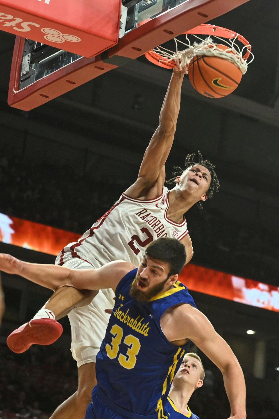 Arkansas forward Trevon Brazile (2) dunks the ball over South Dakota State forward Broden Lien (33) during the second half of an NCAA college basketball game Wednesday, Nov. 16, 2022, in Fayetteville, Ark. (AP Photo/Michael Woods)