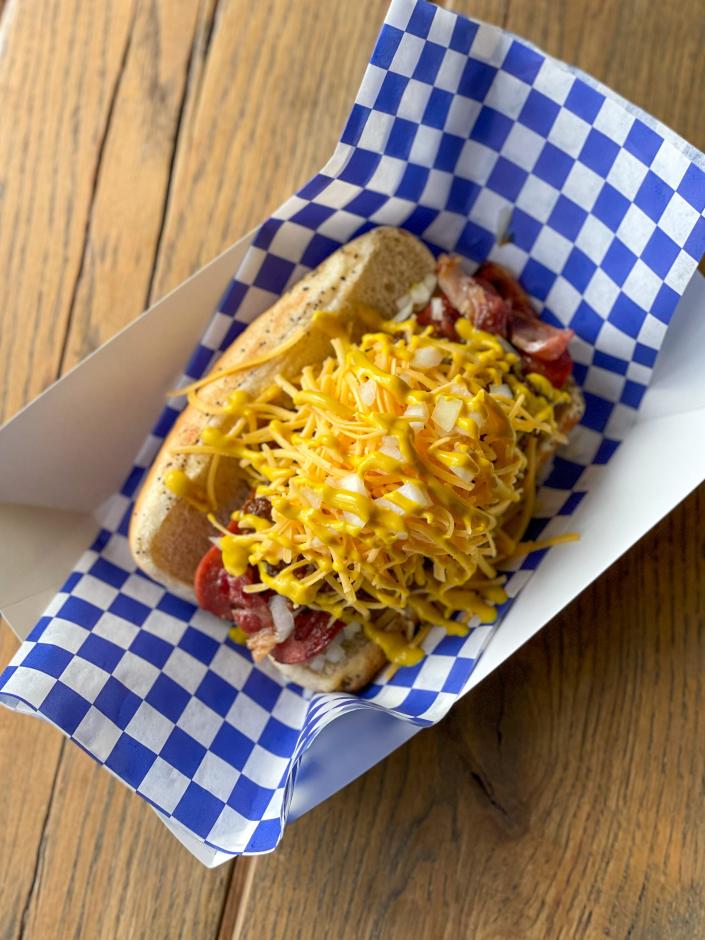 House chili and cheddar top the roughly quarter-pound split and seared chili dog at HotWax, opening April 20.