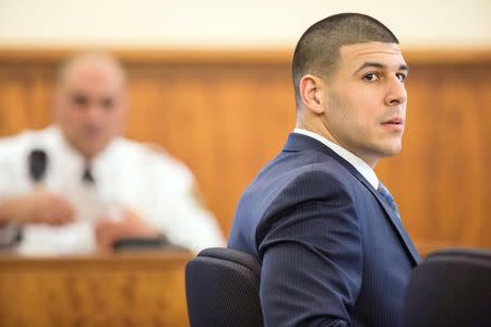 Former New England Patriots player Aaron Hernandez sits during his murder trial at the Bristol County Superior Court in Fall River, Massachusetts, March 9, 2015. REUTERS/Aram Boghosian/Pool