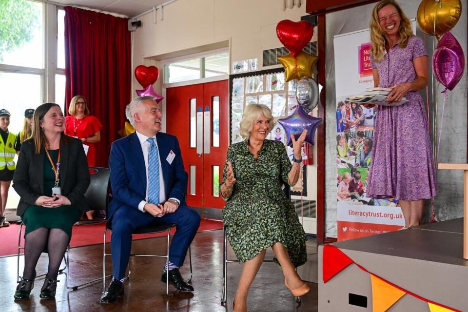 Camilla, Duchess of Cornwall is presented with books during her visit to Millbrook Primary School on July 06, 2022 in Newport, Wales