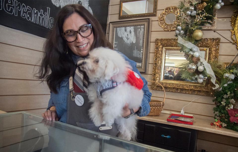 (11/27/21) Owner Grace Quaschnick holds her pet dog Puffy who is the namesake of Puffy's Thrift Mercantile during the Miracle MIle's Sip and Stroll wine tasting/shopping event in Stockton. CLIFFORD OTO/THE STOCKTON RECORD