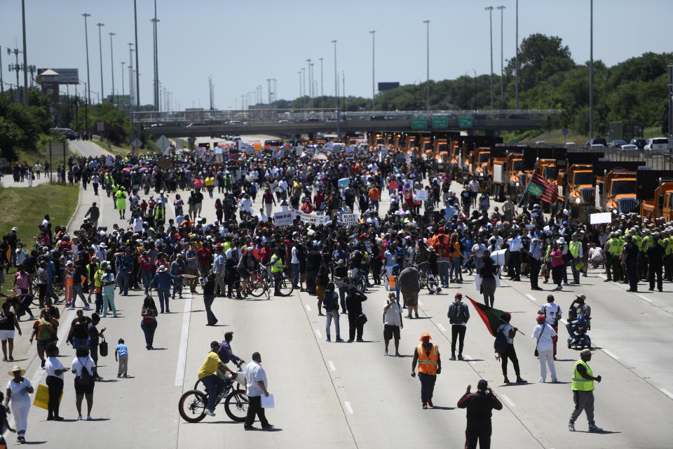 In this Saturday, July 7, 2018, photo, protesters march on the Dan Ryan Expressway in Chicago. The protesters shut down the expressway in an attempt to increase pressure on public officials to address the gun violence that's claimed hundreds of lives in some of the city's poorest neighborhoods. A planned march Thursday, Aug. 2, 2018, along Chicago's picturesque roadway bordering Lake Michigan to one of the most historic baseball stadiums is the latest chapter in the nation's long history of protesters targeting places where they believe their anger goes unnoticed. (AP Photo/Annie Rice)