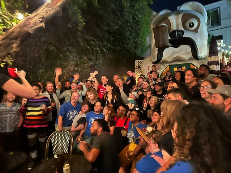 Hollywood workers celebrate a tentative WGA-AMPTP contract agreement outside the North Hollywood bar Idle Hour.