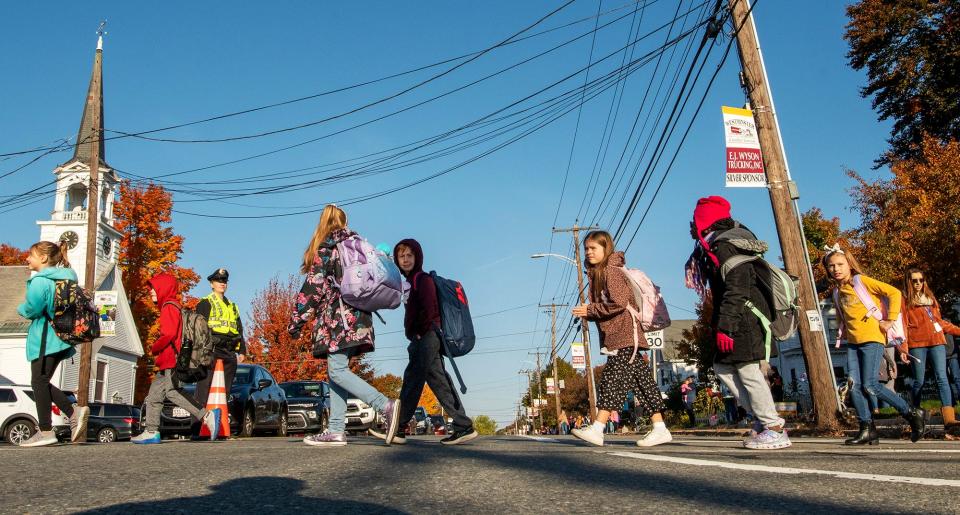 Students cross Main Street on their half-mile journey Wednesday to Meetinghouse School and Westminster Elementary School on Walk, Bike & Roll to School Day.