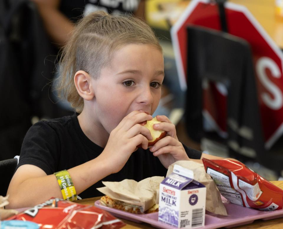 Theo Bash, 8, bites into an apple at lunch at Perry High School. Perry Local Schools is offering free breakfast and free lunch to any child ages 18 and younger as part of Ohio's Summer Food Service Program.