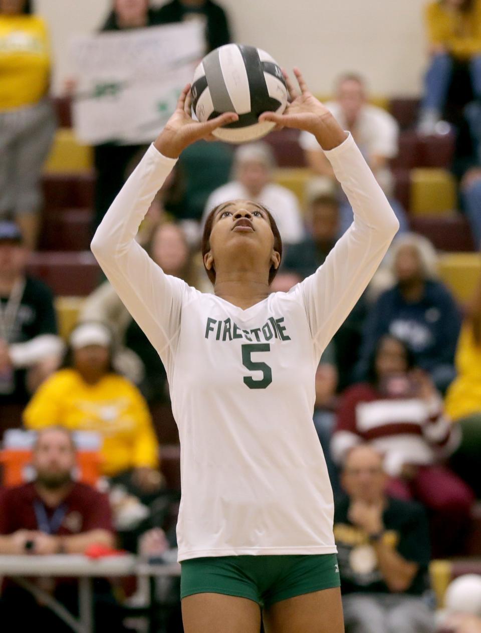 Firestone's Emani Myers sets the ball for a teammate in the game against Ellet in the City Series volleyball championship on Thursday, Oct. 13, 2022 in Akron, Ohio, at Garfield High School.