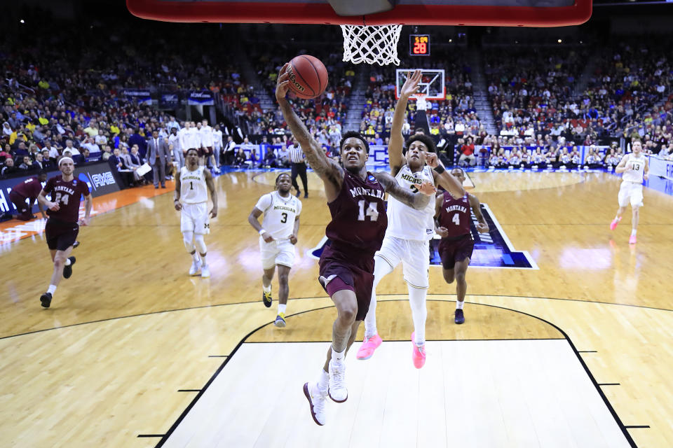 <p>Ahmaad Rorie #14 of the Montana Grizzlies drives to the basket against Jordan Poole #2 of the Michigan Wolverines in the first half during the first round of the 2019 NCAA Men’s Basketball Tournament at Wells Fargo Arena on March 21, 2019 in Des Moines, Iowa. </p>