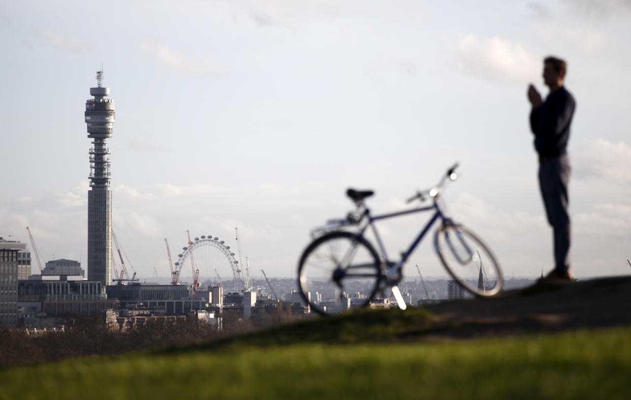 A file photograph shows a man looking towards the BT Telecom Tower, from Primrose Hill in London, Britain, December 29, 2015.  Britain's BT should be forced to spin off its national broadband network to improve speeds and quality of service, an independent report backed by more than 100 lawmakers said on January 23, 2016. REUTERS/Peter Nicholls/Files