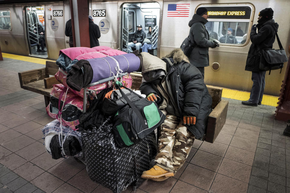 FILE - A homeless man sleeps with his belongings on a subway platform bench in New York on Jan. 10, 2017. The City Council unanimously approved a “Homeless Bill of Rights” in April 2023 that would make New York the first big U.S. city to establish an explicit right to sleep in at least some public places. If Mayor Eric Adams, a Democrat, allows the measure to become law, it could be a notable departure for the city — which has for years sent police and sanitation crews to clear homeless encampments as they arise. (AP Photo/Mark Lennihan, File)